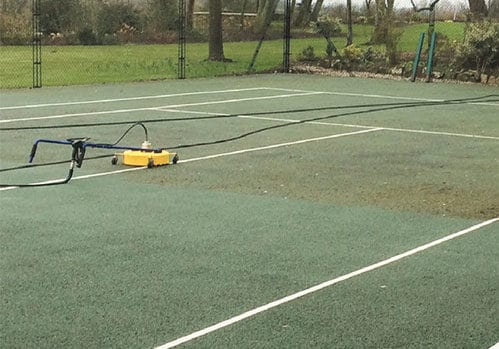 EnTC cleaning a tarmac tennis court