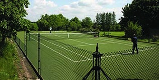 Tennis court fences remove the need for hedging and deter moss.